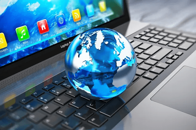 A blue and white globe on a laptop keyboard symbolizing global connectivity.